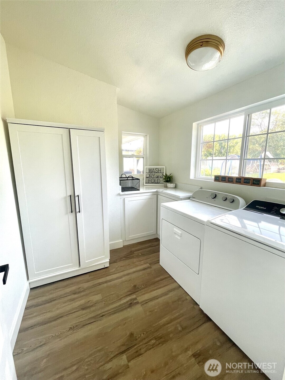 6694 Mae Valley Road Northeast Moses Lake, WA 98837 - Photo 18 of 26 a kitchen with white cabinets and white appliances