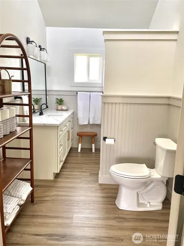 a bathroom with a sink a toilet and a window