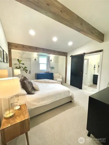 a bedroom with a bed and large mirror