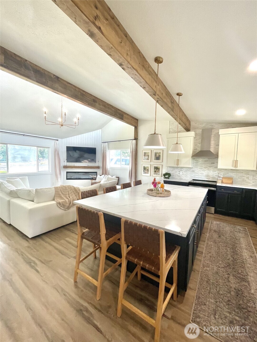 6694 Mae Valley Road Northeast Moses Lake, WA 98837 - Photo 6 of 26 a kitchen with stainless steel appliances kitchen island granite countertop a table chairs sink and cabinets