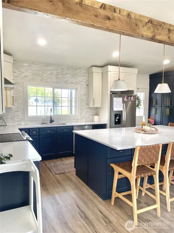 a large kitchen with a table and chairs in it