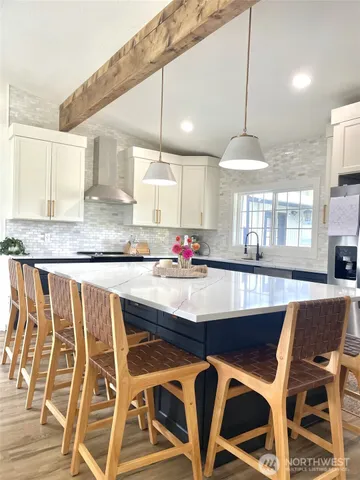 a kitchen with a table chairs sink and cabinets