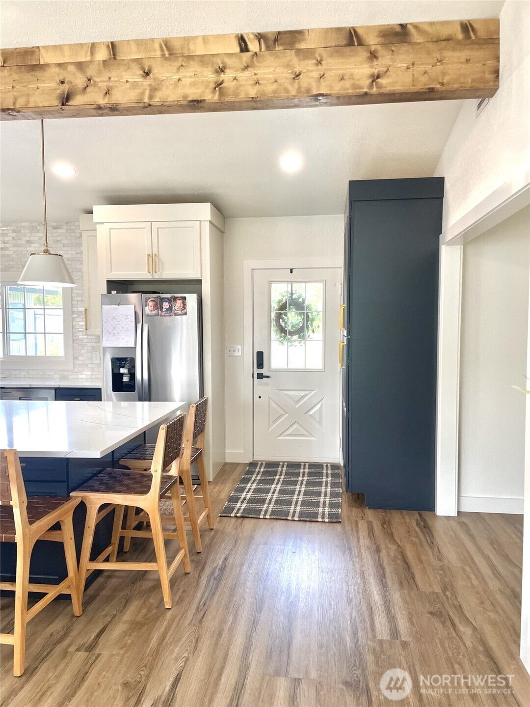 6694 Mae Valley Road Northeast Moses Lake, WA 98837 - Photo 10 of 26 an open kitchen with granite countertop a stove and white cabinets