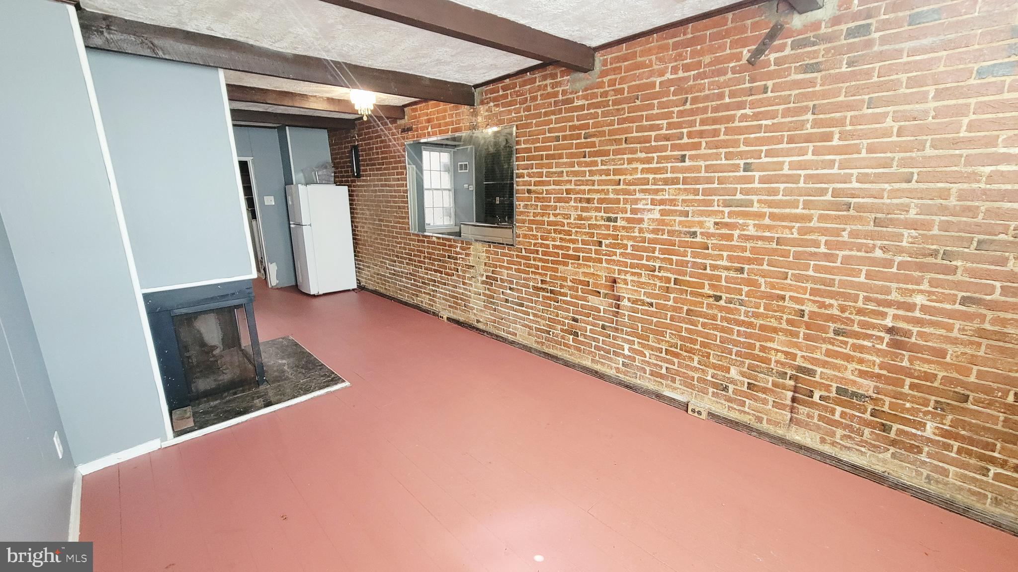 703 Tessier Street Baltimore, MD 21201 - Photo 4 of 19 1st level living room with exposed brick