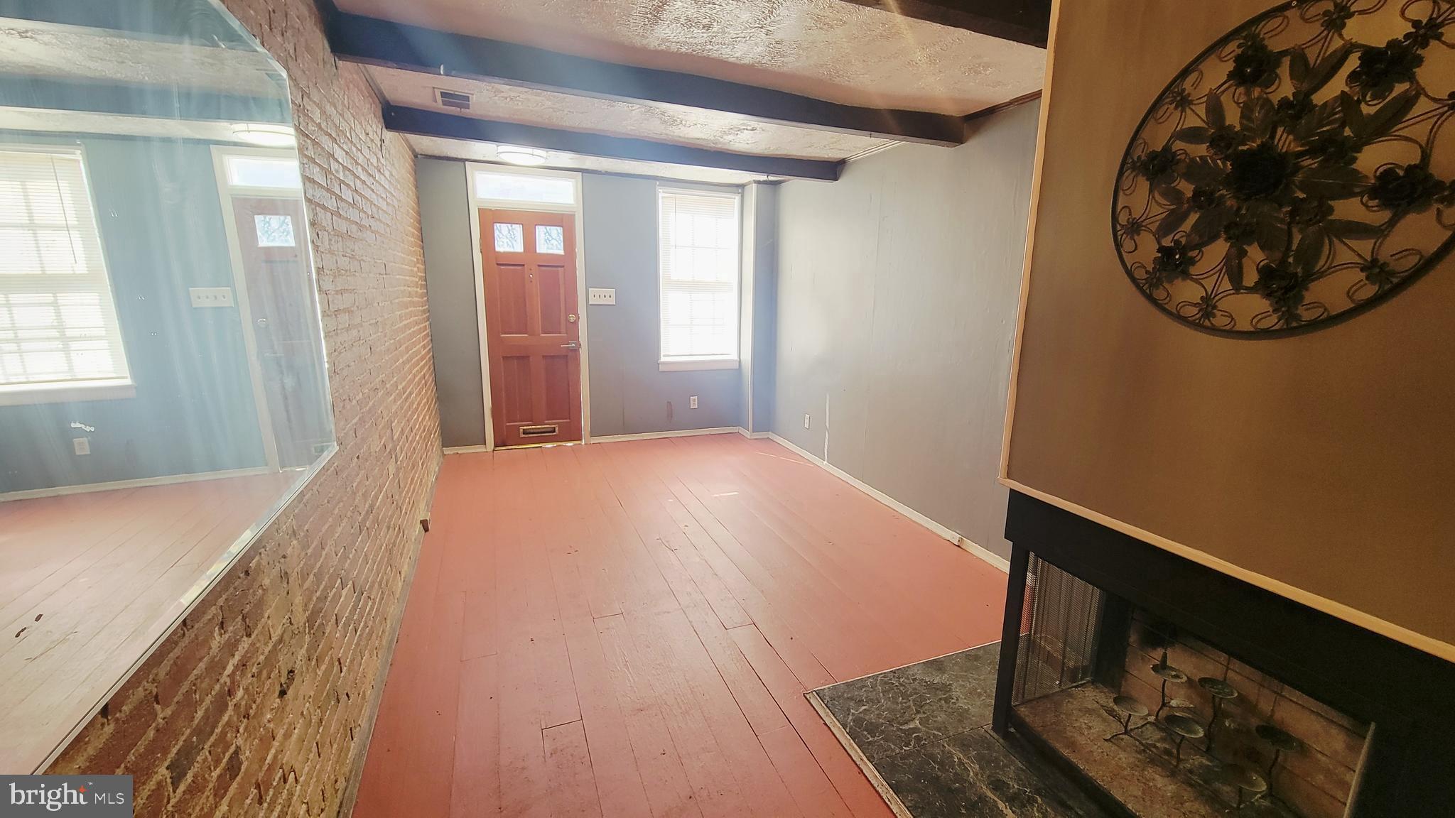 703 Tessier Street Baltimore, MD 21201 - Photo 5 of 19 1st level living room with exposed brick