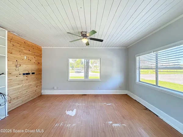 wooden floor in an empty room with a window