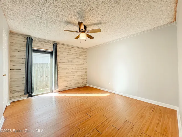 a view of room with hardwood floor and ceiling fan