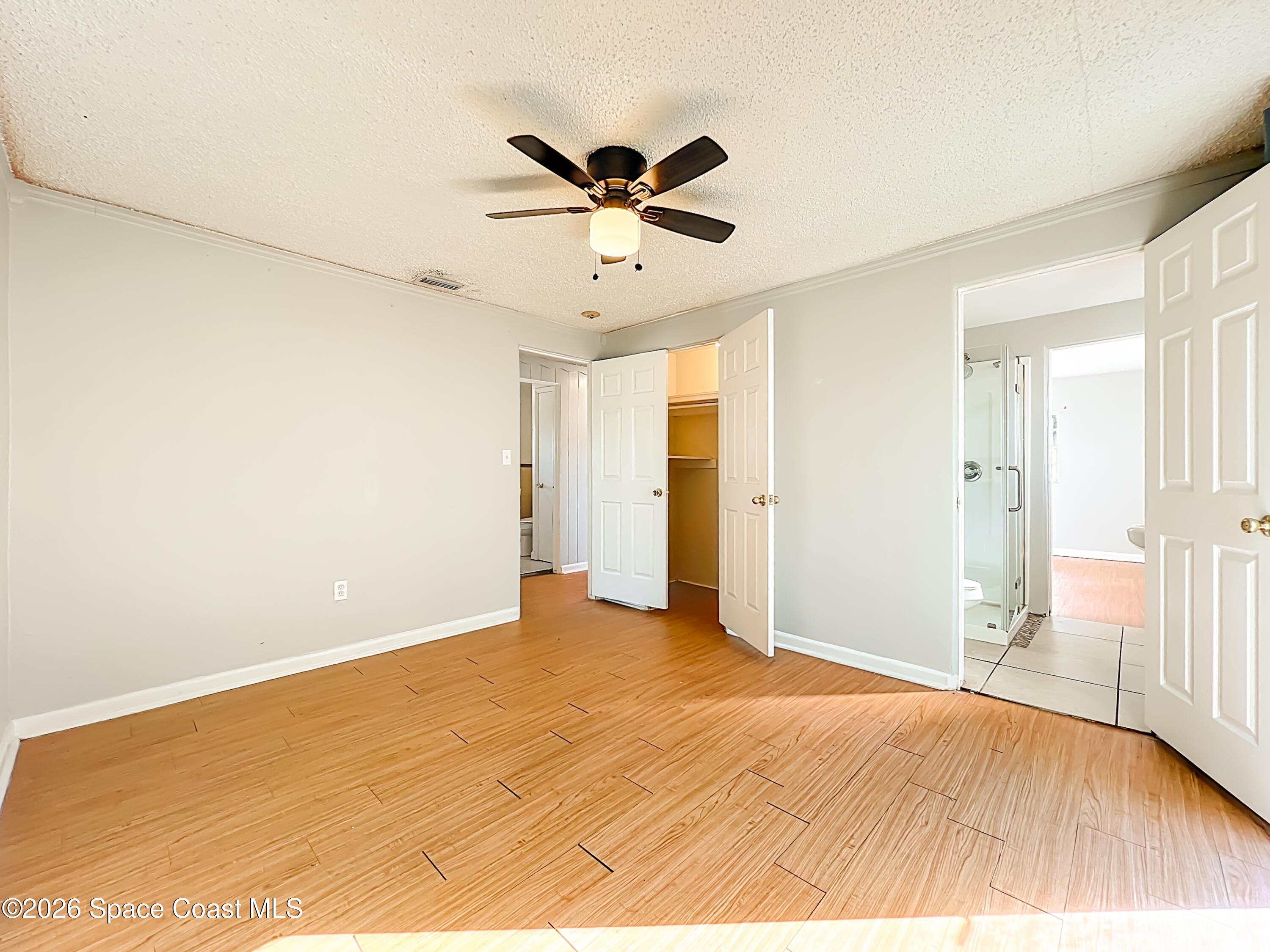 541 East Fee Avenue Melbourne, FL 32901 - Photo 13 of 28 a view of empty room with wooden floor and ceiling fan