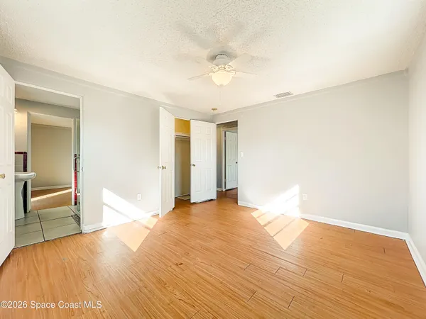 a view of empty room with wooden floor