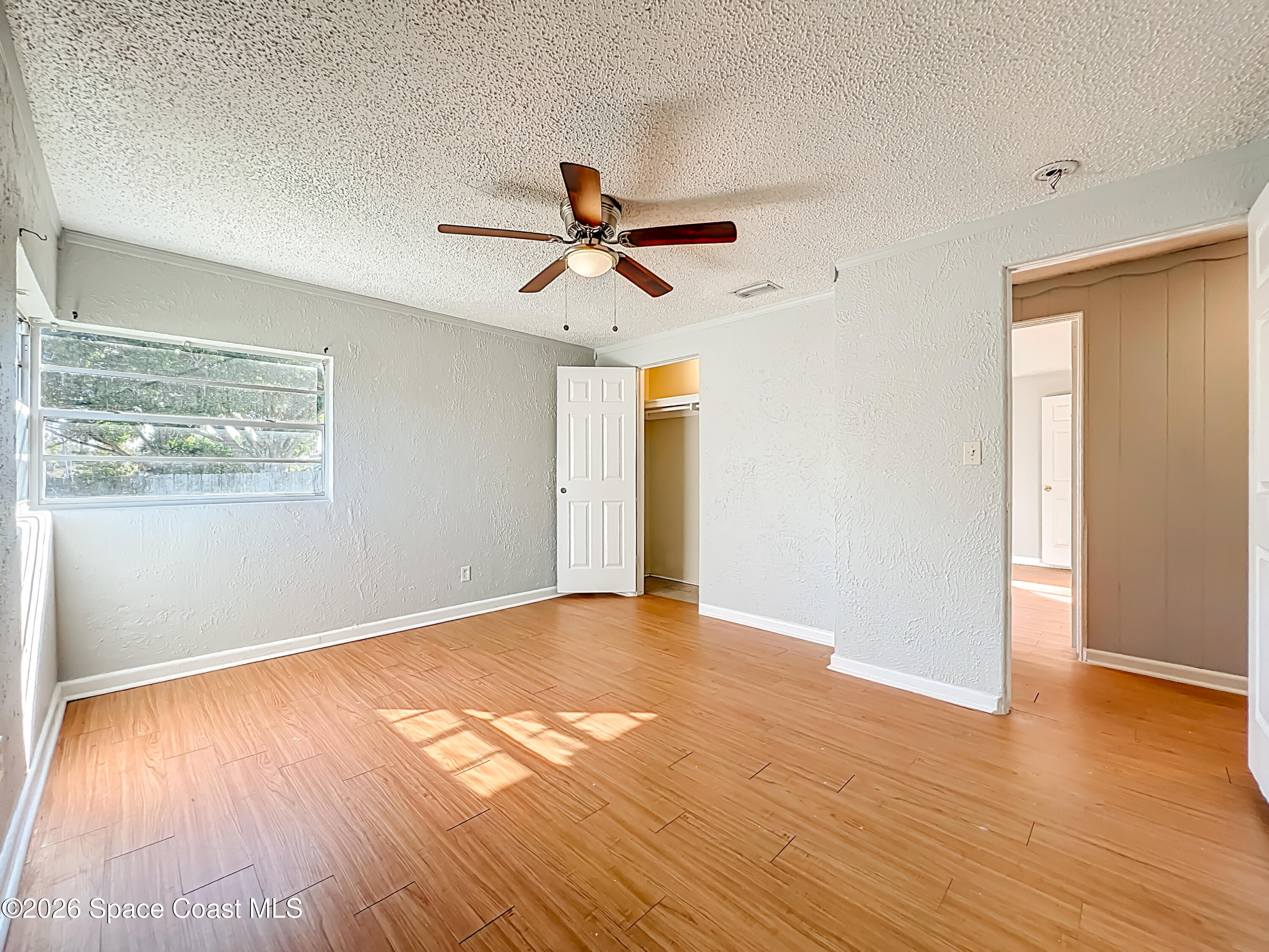 541 East Fee Avenue Melbourne, FL 32901 - Photo 19 of 28 a view of empty room with wooden floor and fan