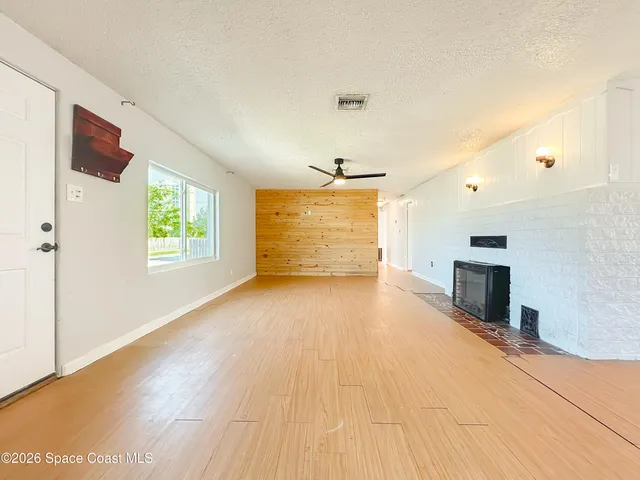 a view of empty room with a fireplace