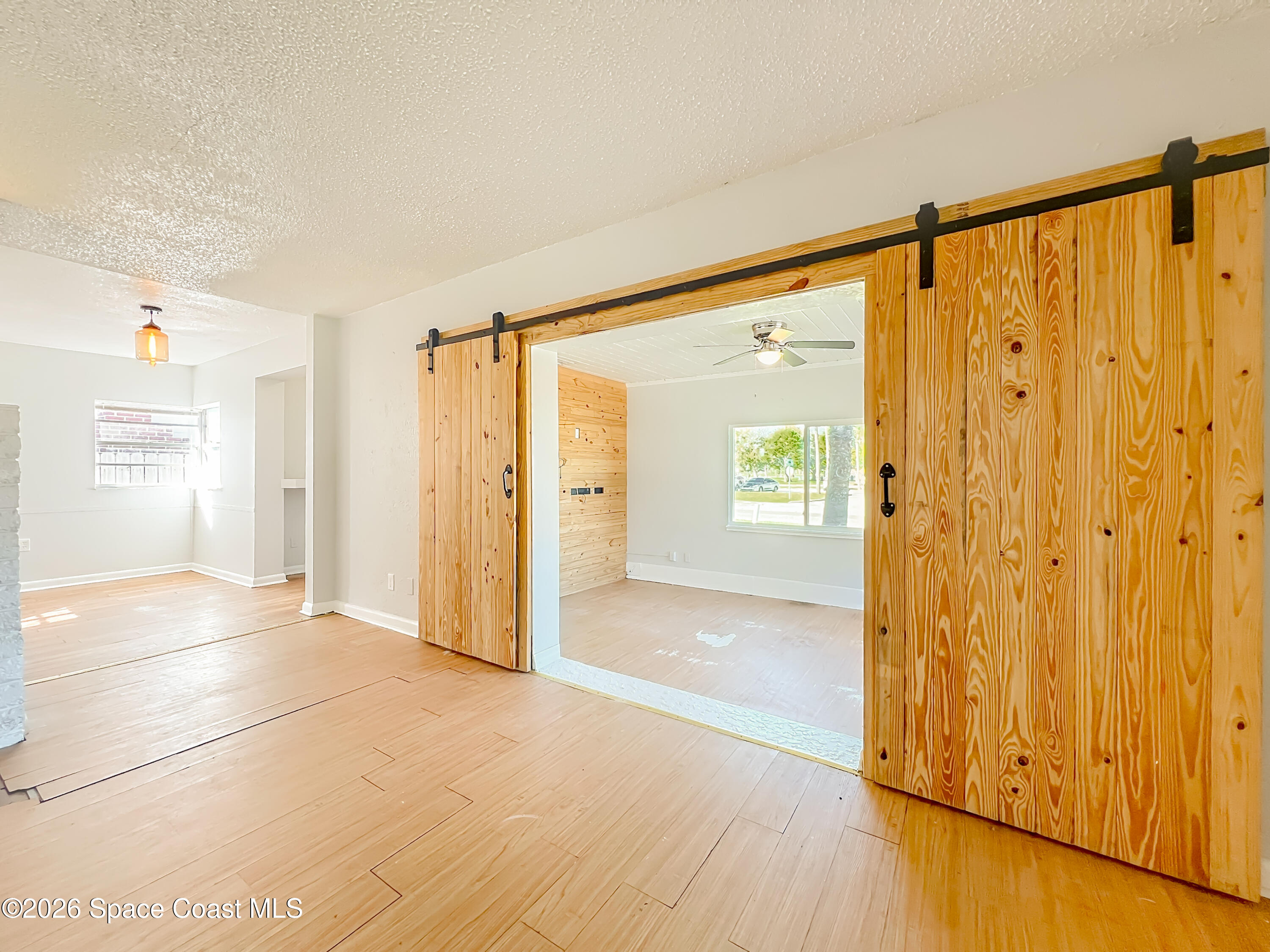 541 East Fee Avenue Melbourne, FL 32901 - Photo 5 of 28 a view of a hallway with wooden floor and a cabinet