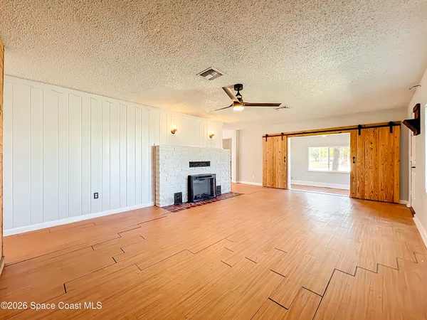 a view of a livingroom with a fireplace and window