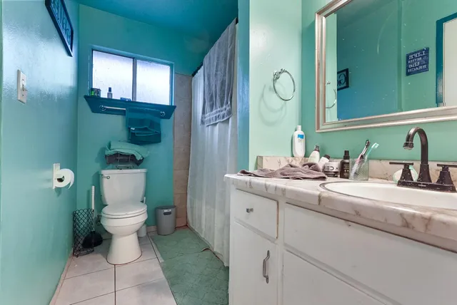 a bathroom with a toilet sink and mirror