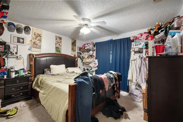 a bedroom with bed and a chandelier