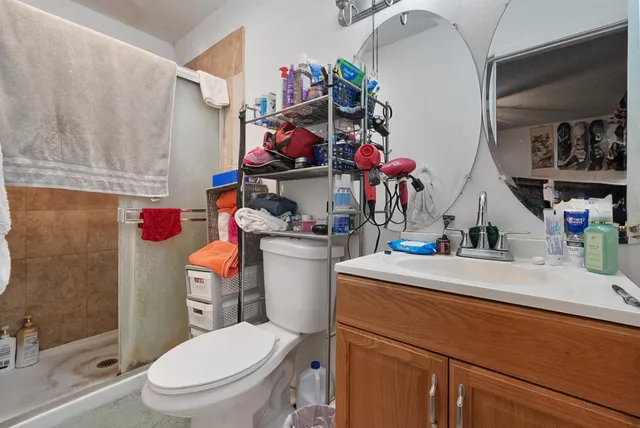 a bathroom with a sink a toilet and a shower curtain