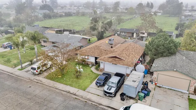an aerial view of multiple houses with yard
