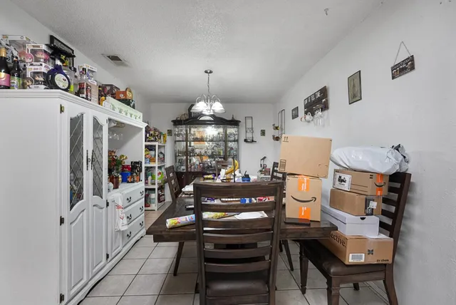 a view of a dining room with furniture and chandelier