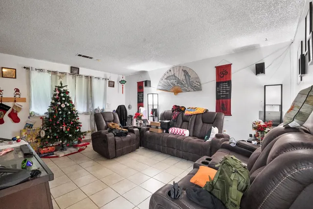 a living room with furniture a fireplace and a window