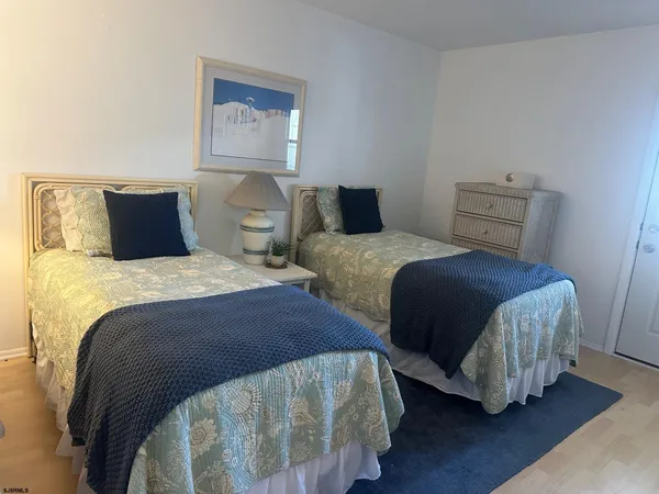 a bedroom with two beds and a chandelier