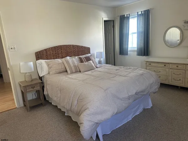 a bedroom with two beds and a window