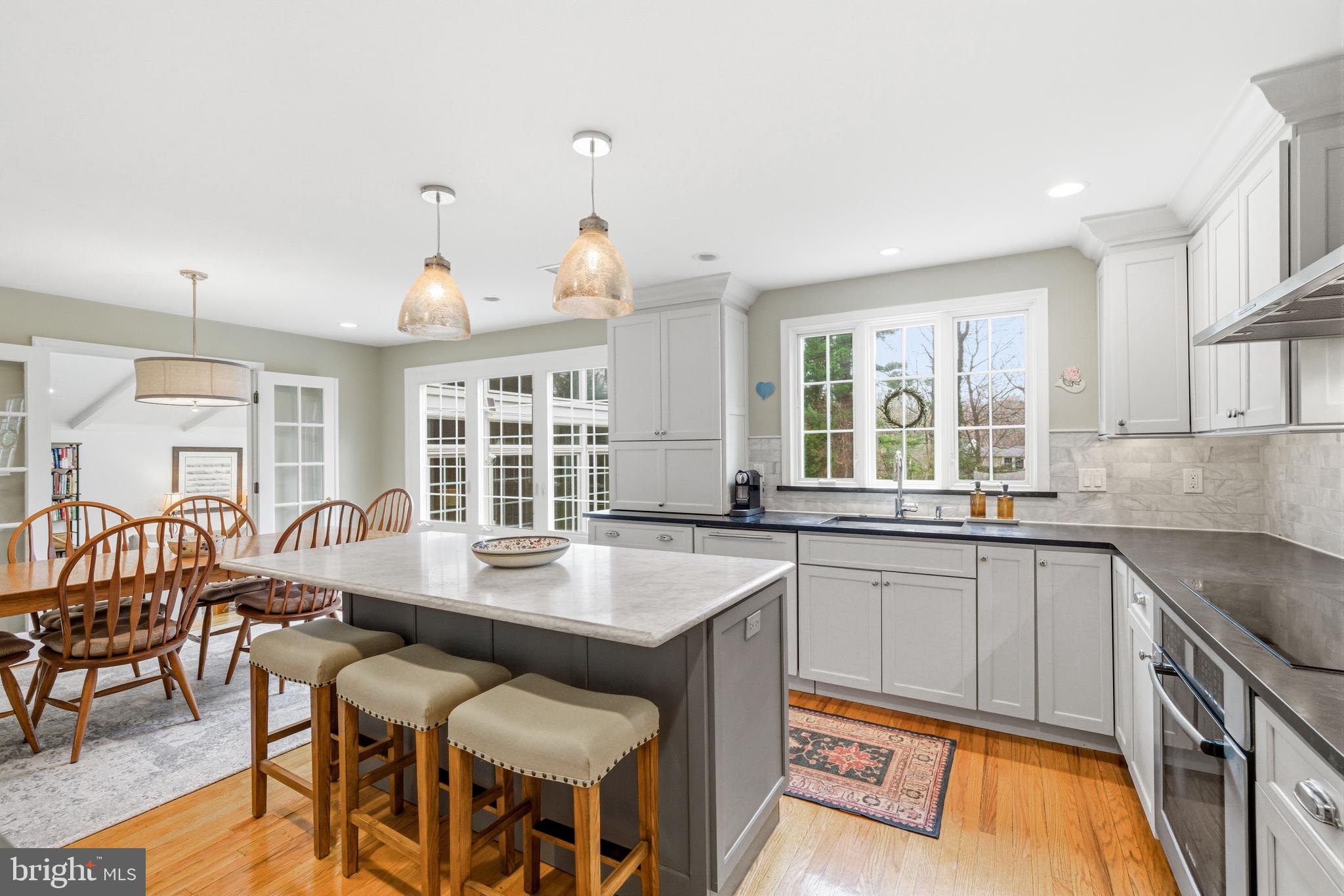371 Margo Lane Berwyn, PA 19312 - Photo 11 of 68 a kitchen with a table chairs stove and cabinets