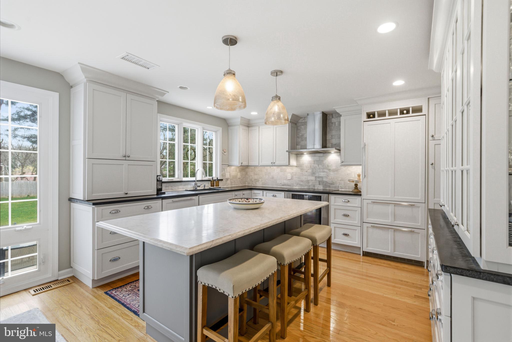 371 Margo Lane Berwyn, PA 19312 - Photo 13 of 68 a kitchen with kitchen island a stove a sink and a refrigerator