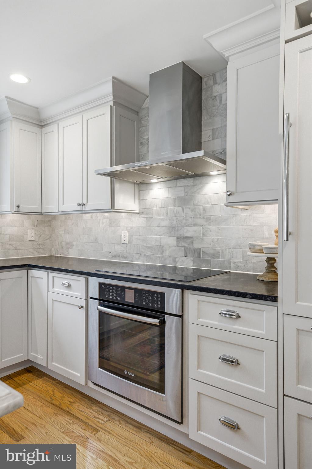371 Margo Lane Berwyn, PA 19312 - Photo 18 of 68 a kitchen with granite countertop white cabinets stainless steel appliances and sink