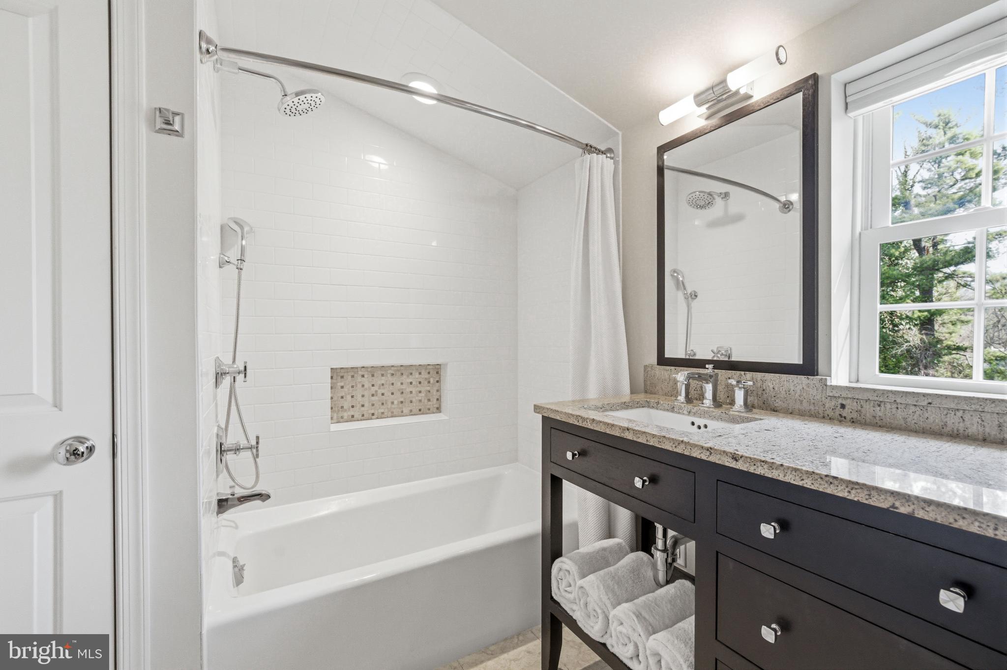 371 Margo Lane Berwyn, PA 19312 - Photo 40 of 68 a bathroom with a granite countertop sink mirror vanity and a bathtub