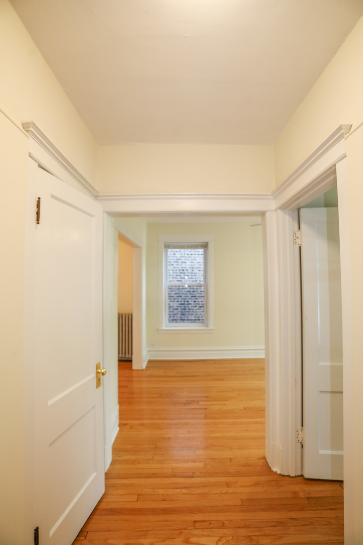 1848 West Grace Street, Unit 2E Chicago, IL 60613 - Photo 11 of 13 a view of an empty room with wooden floor and a window