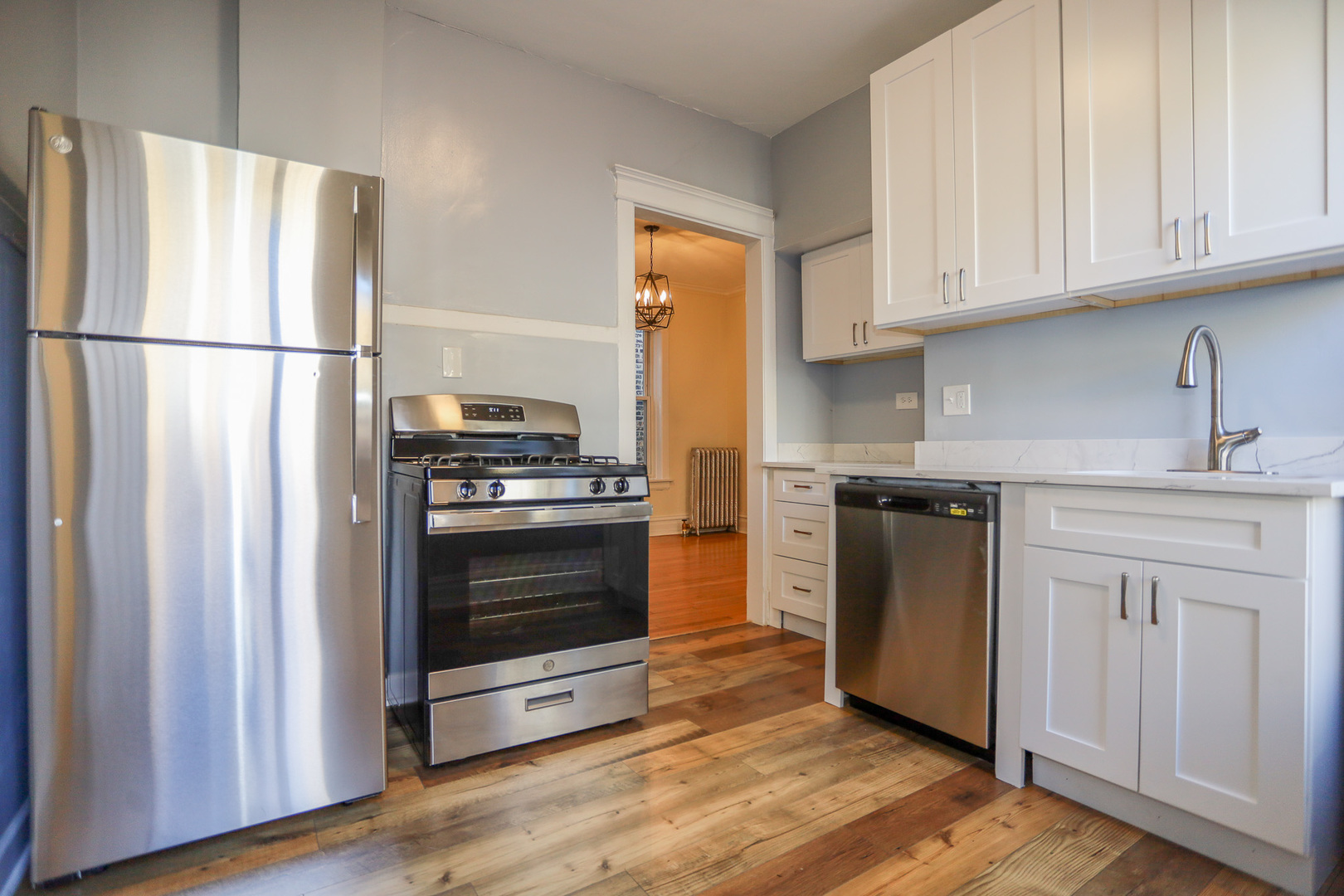 1848 West Grace Street, Unit 2E Chicago, IL 60613 - Photo 2 of 13 a kitchen with stainless steel appliances granite countertop a refrigerator and a stove top oven