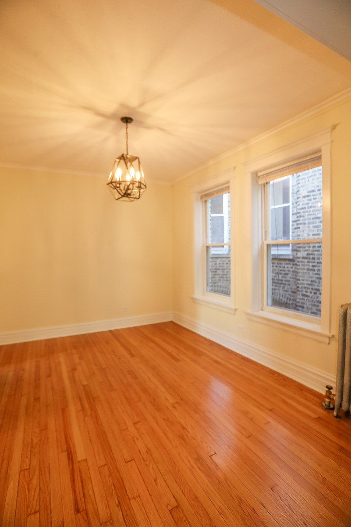 1848 West Grace Street, Unit 2E Chicago, IL 60613 - Photo 8 of 13 a view of empty room with wooden floor and fan