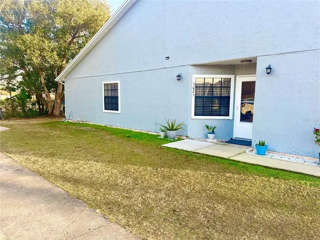 a view of a house with swimming pool and a yard