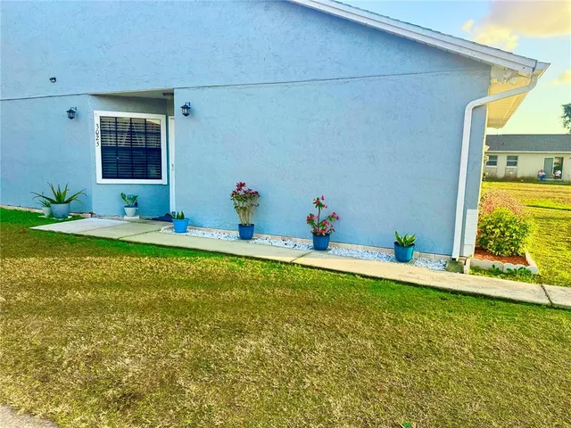 a view of a house with a backyard space and balcony