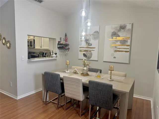 a dining room with a wooden table and chairs