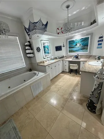 a large white kitchen with a stove a sink dishwasher and a oven with wooden floor