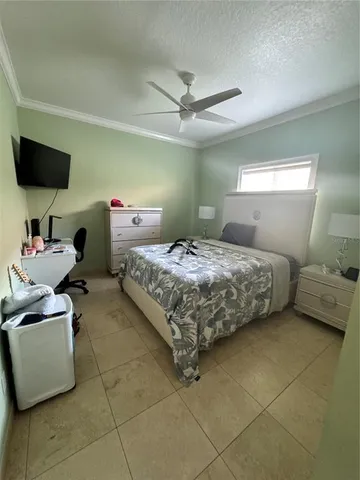 a bedroom with a bed and a lamp on the dresser