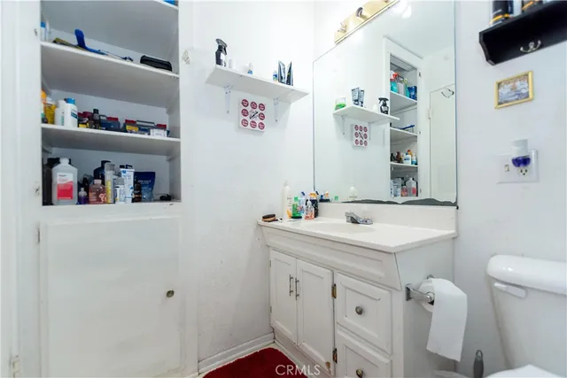 a bathroom with a sink a toilet and a mirror