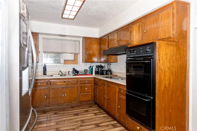 a kitchen with stainless steel appliances a refrigerator and a sink