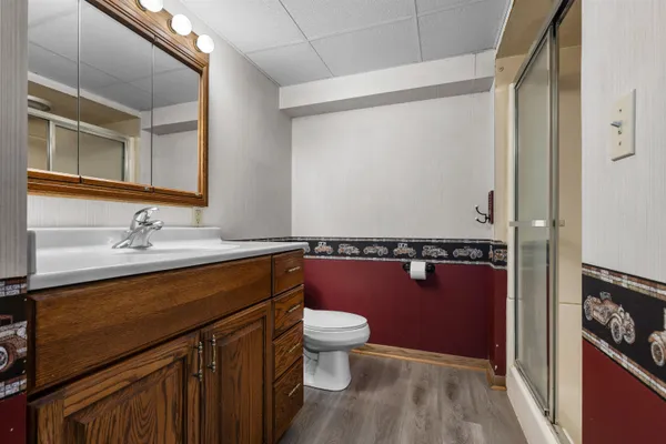 a bathroom with a sink a toilet and a mirror