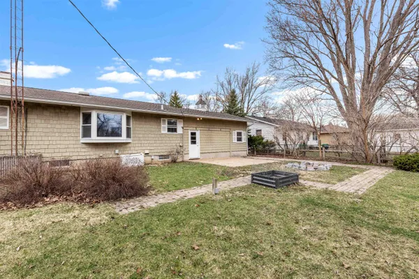 a view of a house with a yard and tree s