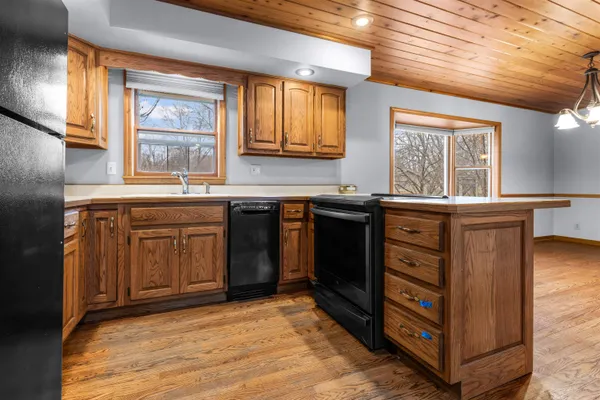 a kitchen with a sink stove and cabinets