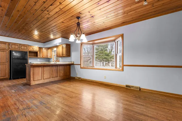 a view of kitchen with cabinets and window