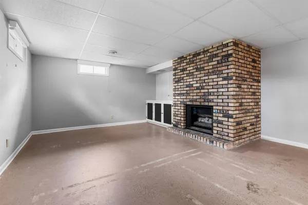 a view of an empty room with a fireplace