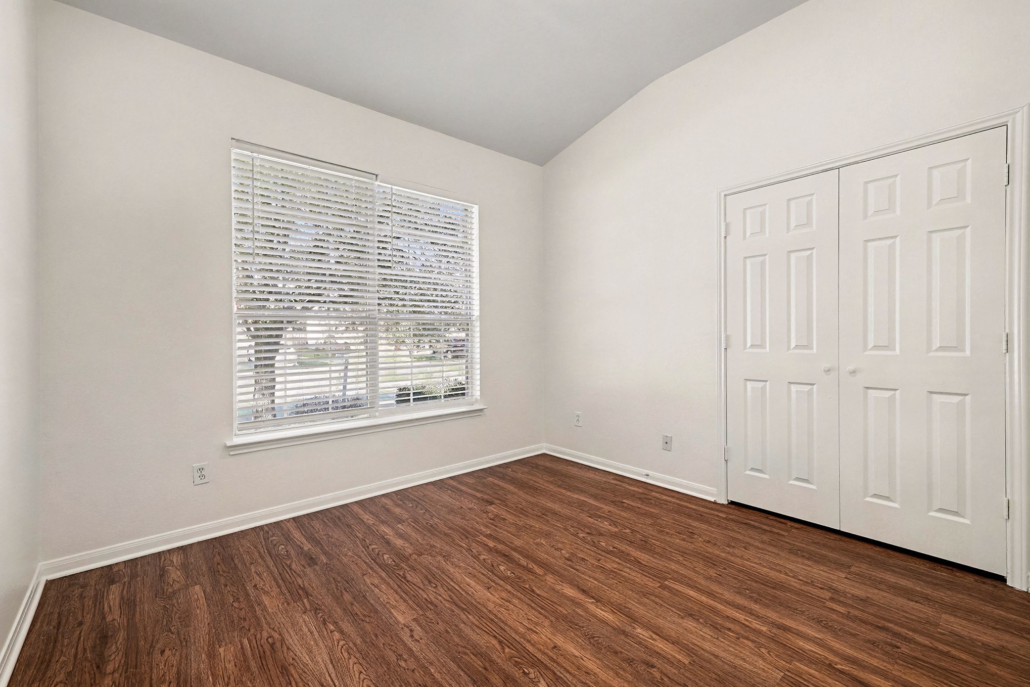 2710 Sleepy Knoll Drive Spring, TX 77373 - Photo 11 of 16 a view of an empty room with wooden floor and a window