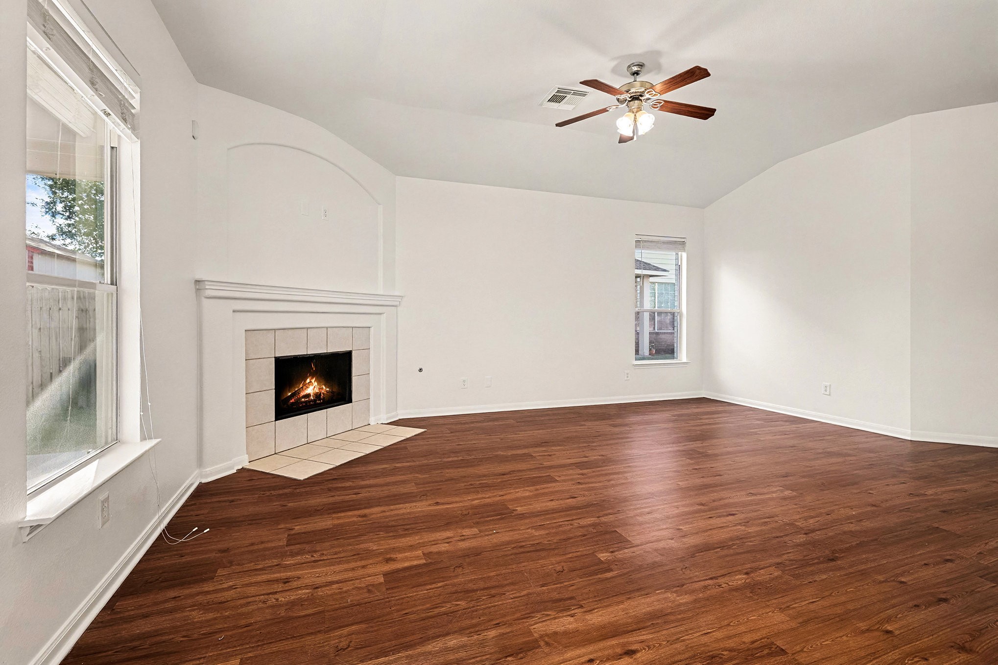 2710 Sleepy Knoll Drive Spring, TX 77373 - Photo 3 of 16 a view of a livingroom with a fireplace a ceiling fan and windows