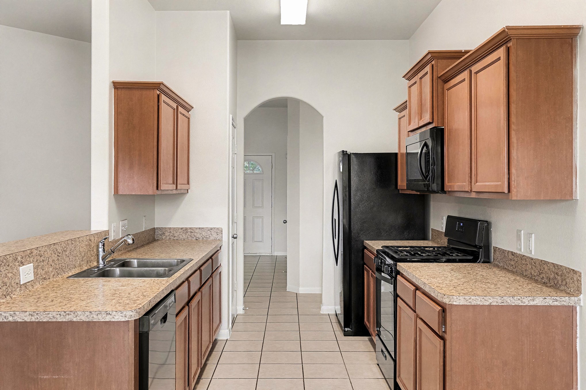 2710 Sleepy Knoll Drive Spring, TX 77373 - Photo 6 of 16 a kitchen with stainless steel appliances granite countertop a sink stove and refrigerator