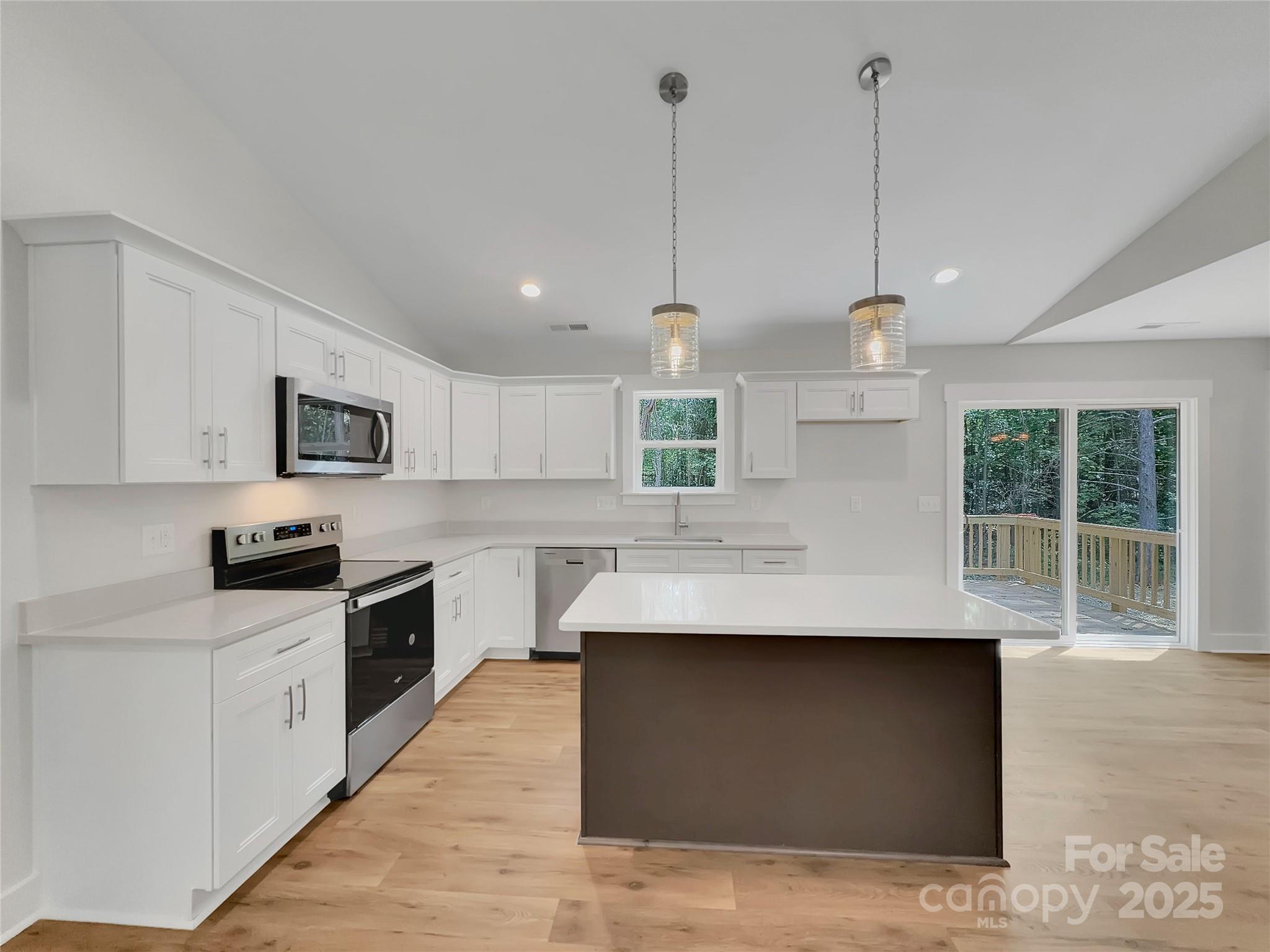 2330 Neill Road Lancaster, SC 29720 - Photo 12 of 39 a kitchen with stainless steel appliances granite countertop a sink a stove and a wooden floors