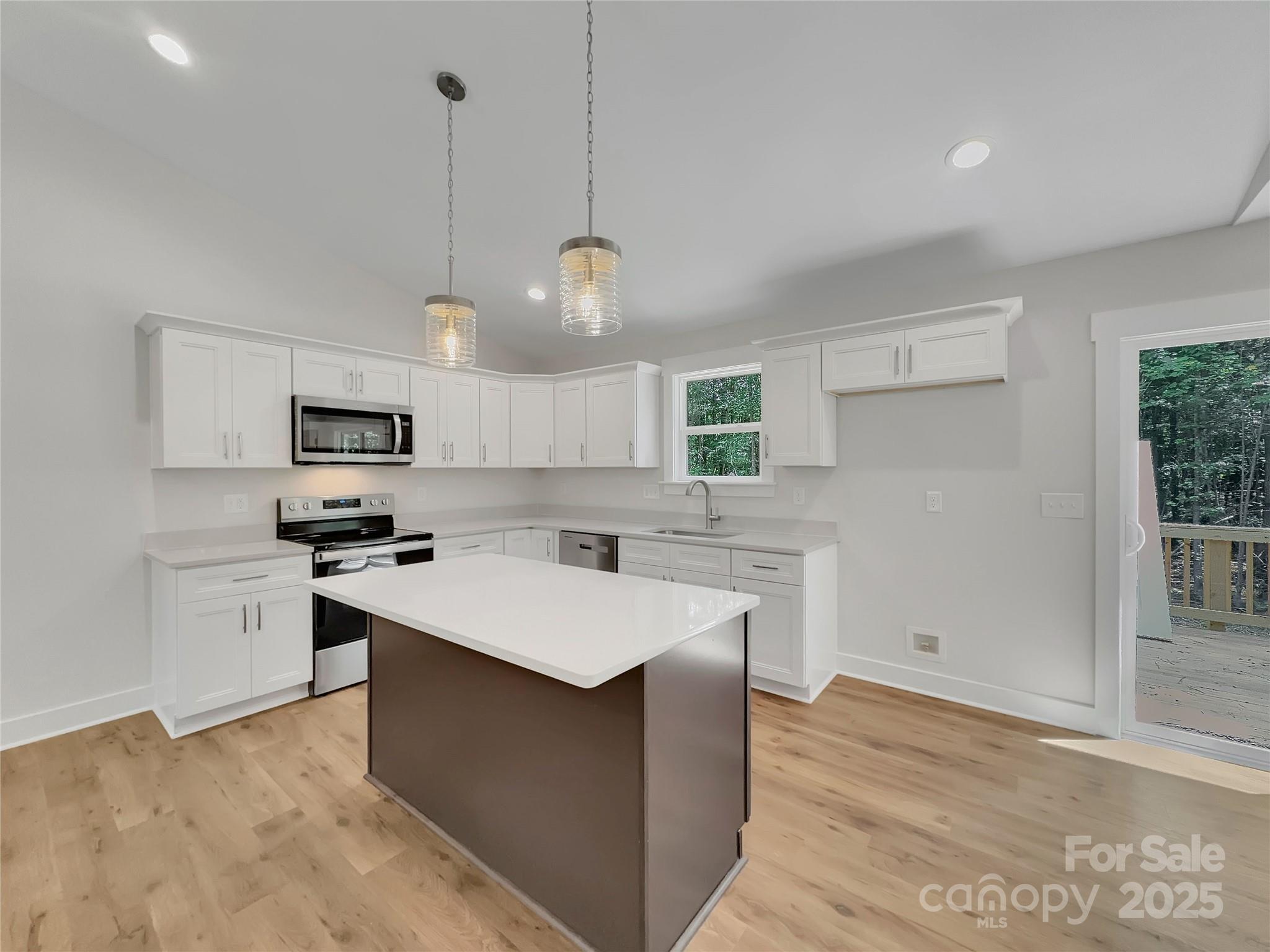 2330 Neill Road Lancaster, SC 29720 - Photo 13 of 39 a kitchen with stainless steel appliances a sink a stove a refrigerator cabinets and a window