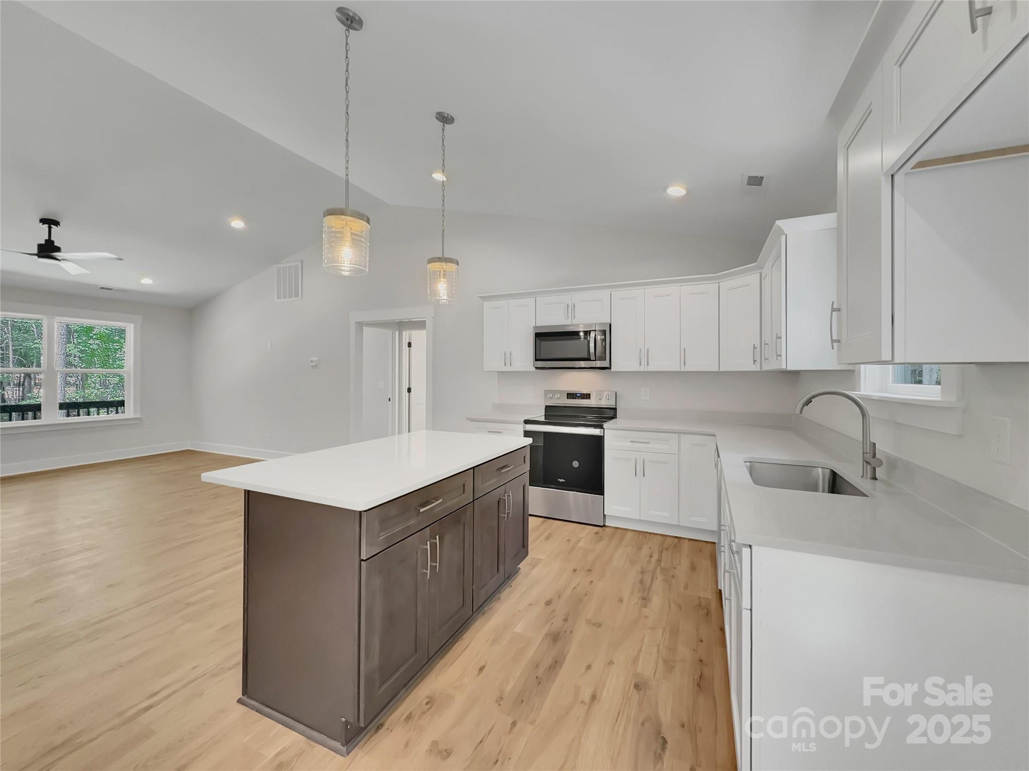 2330 Neill Road Lancaster, SC 29720 - Photo 14 of 39 a large kitchen with stainless steel appliances granite countertop a sink a stove and a wooden floors